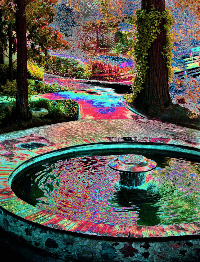 A photograph of trees and a fountain edited to have surreal, bright colors in the highlights.